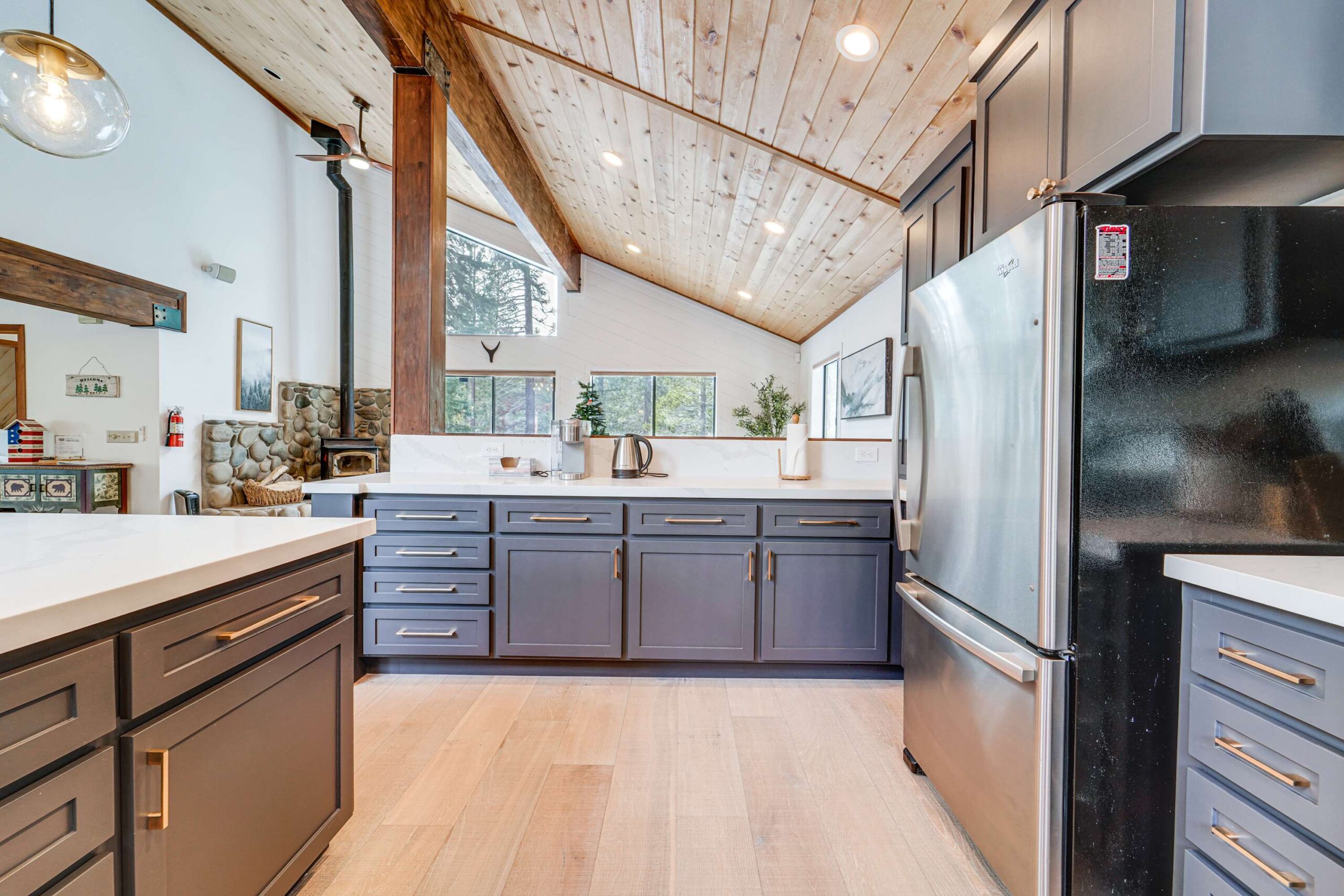 Modern kitchen in a Truckee vacation rental with wood accents, gray cabinets, and stainless steel appliances.