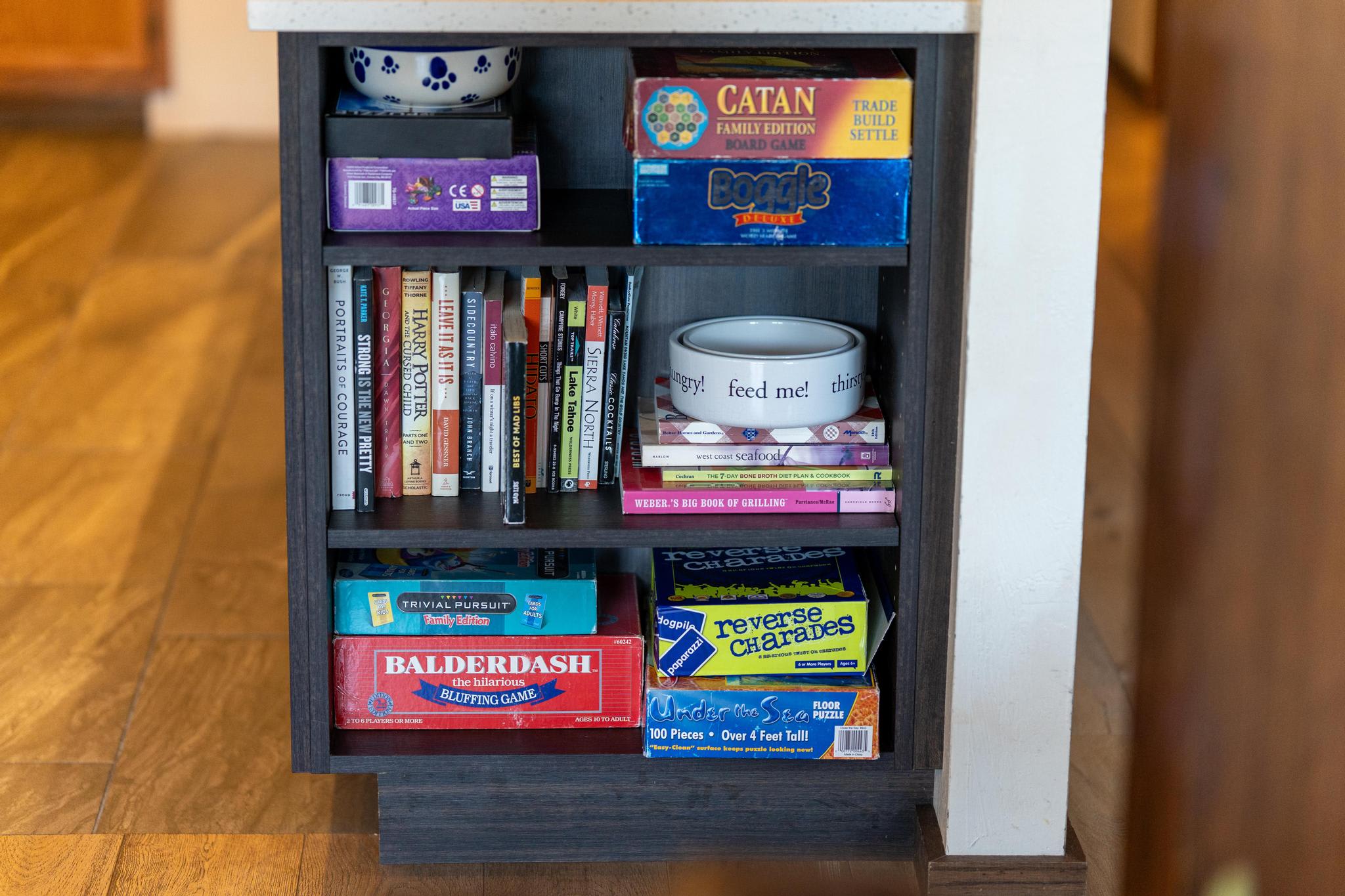 Books and games shelf in a Tahoe Vista vacation rental.