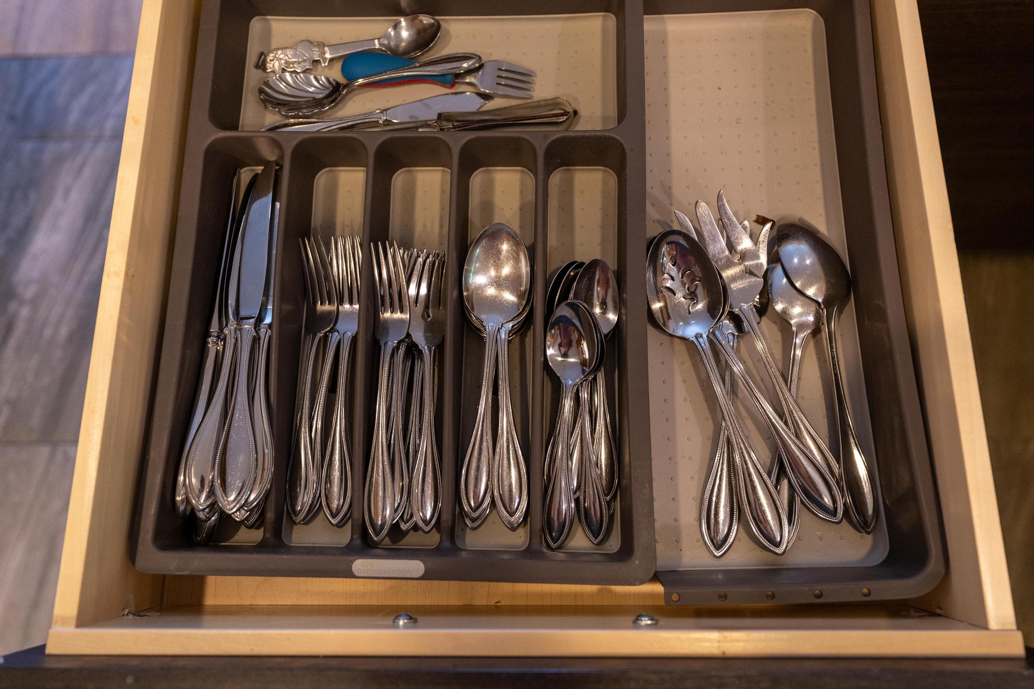 Drawer of cutlery in a Tahoe Vista vacation rental, neatly organized with forks, knives, and spoons.