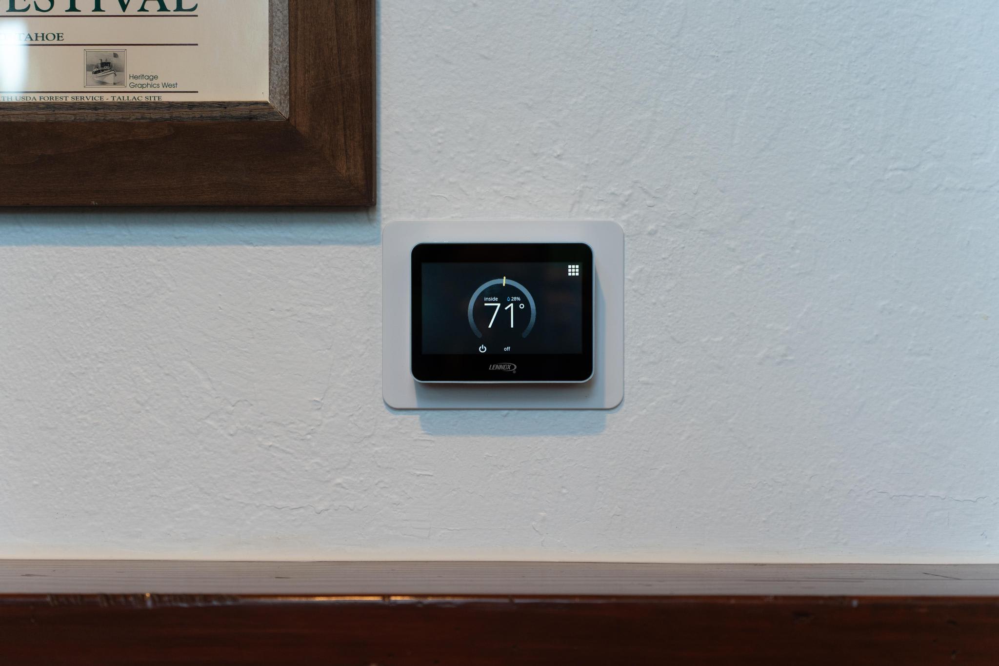 Smart thermostat set to 71°F on a wall in a Truckee vacation rental.
