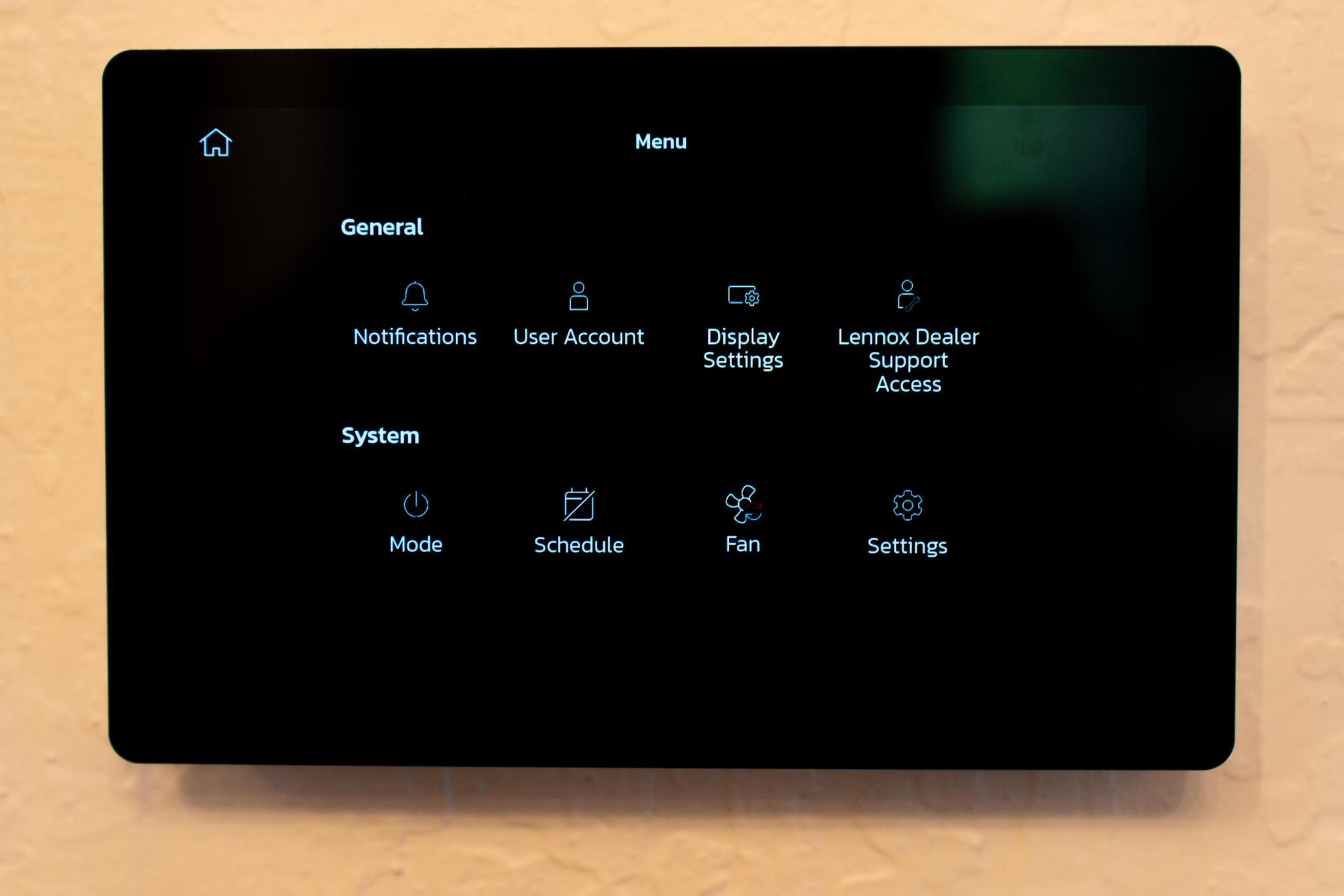 Touchscreen climate control panel in a Truckee vacation rental, displaying general and system settings.
