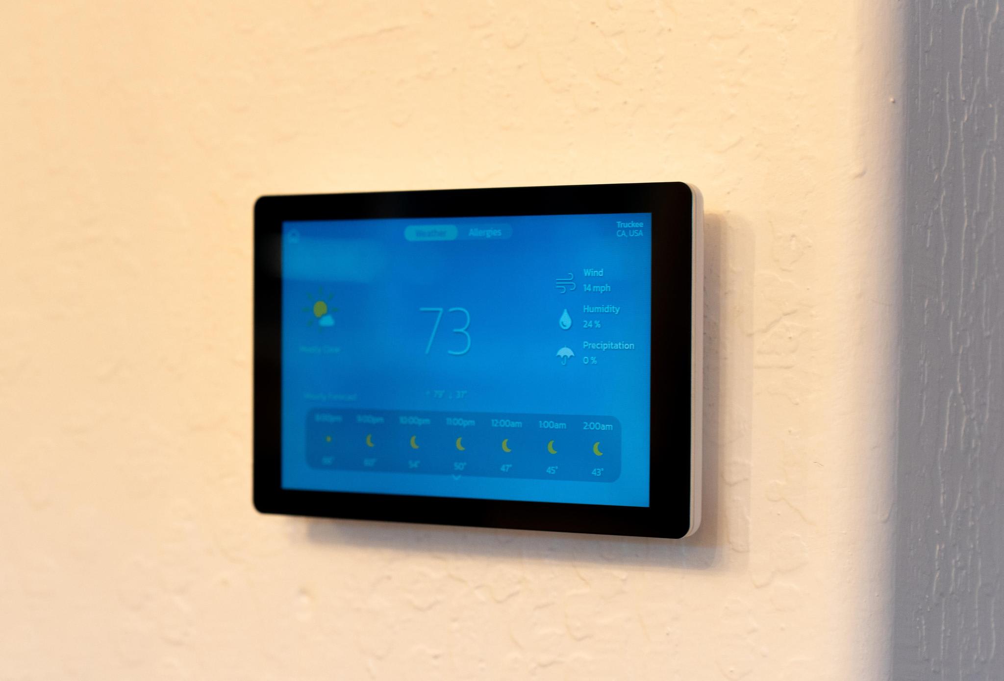 Smart thermostat showing weather info at 73°F in a Truckee vacation rental home.