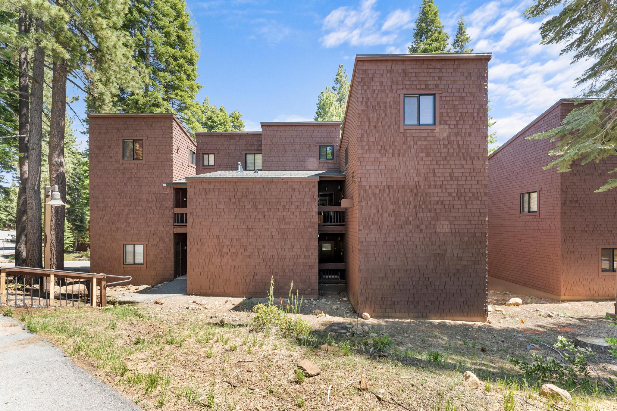 Brown wooden building in Truckee surrounded by trees, ideal for a vacation rental getaway.