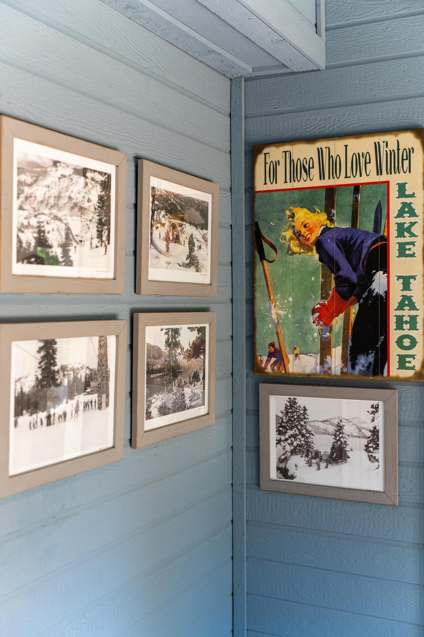 Wall art in Truckee vacation rental featuring vintage Lake Tahoe winter posters and photos.