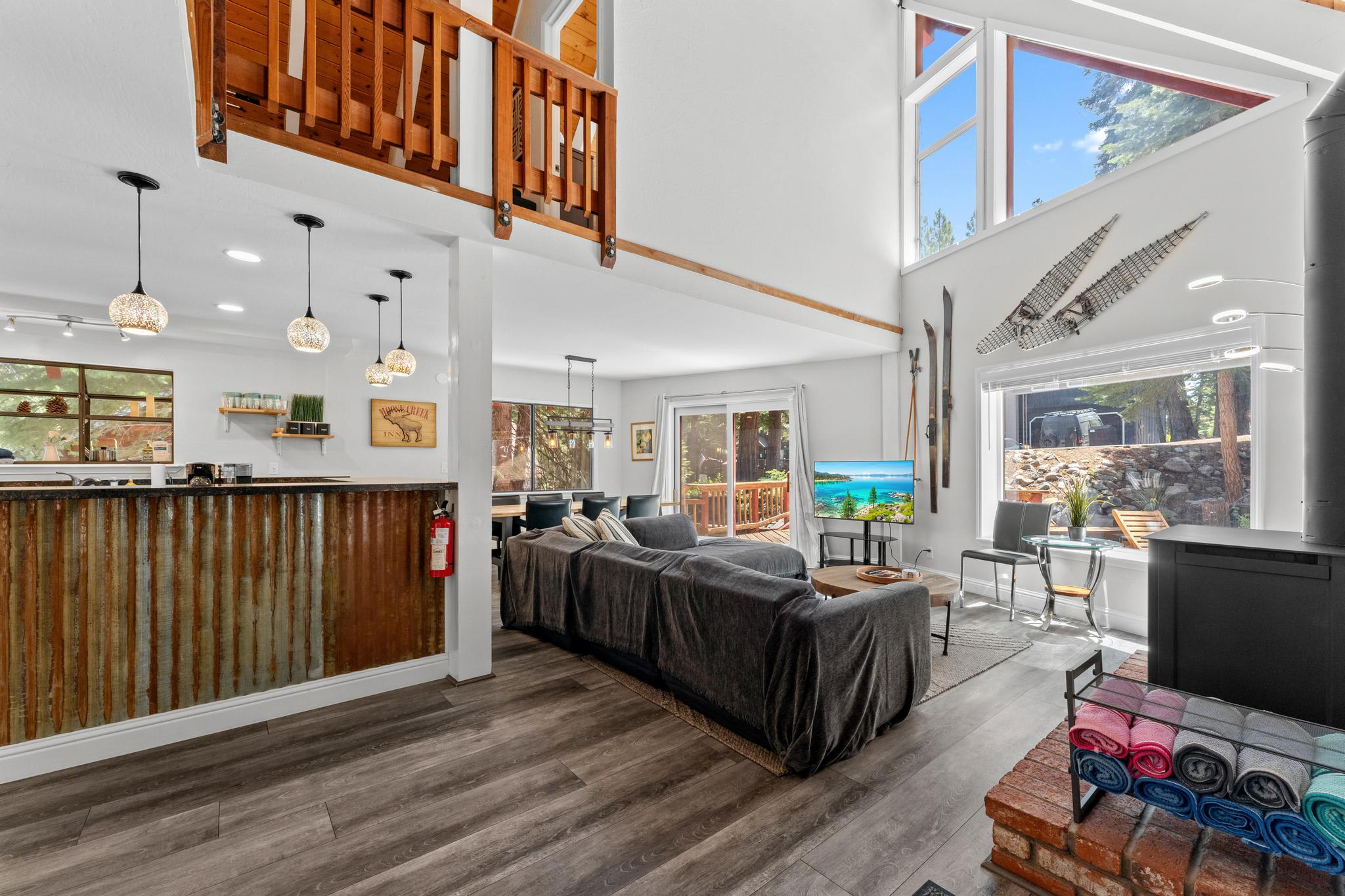 Stylish Tahoe Vista vacation rental with open living space, modern kitchen, large windows, and cozy seating.