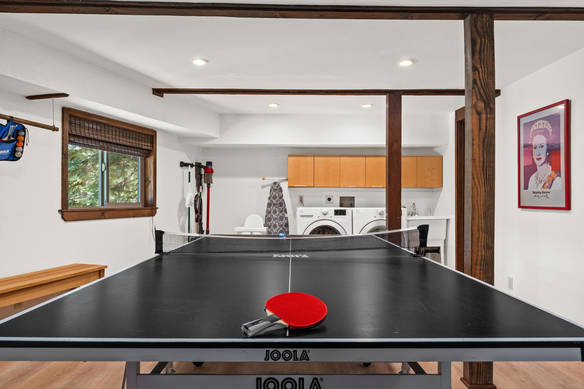 Ping pong table in a Tahoe Vista vacation rental with laundry area in the background.