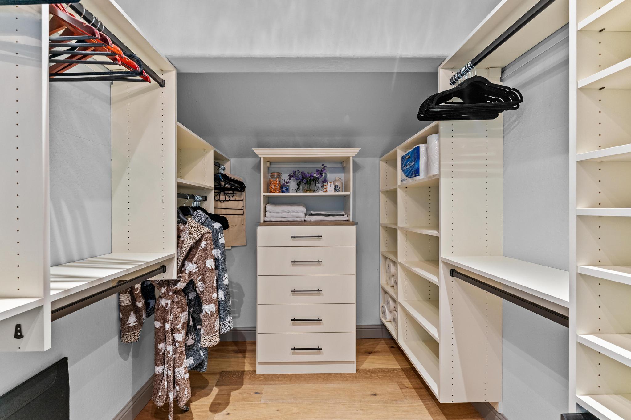 Spacious walk-in closet with robes and shelves in a Truckee vacation rental, featuring organized storage solutions.