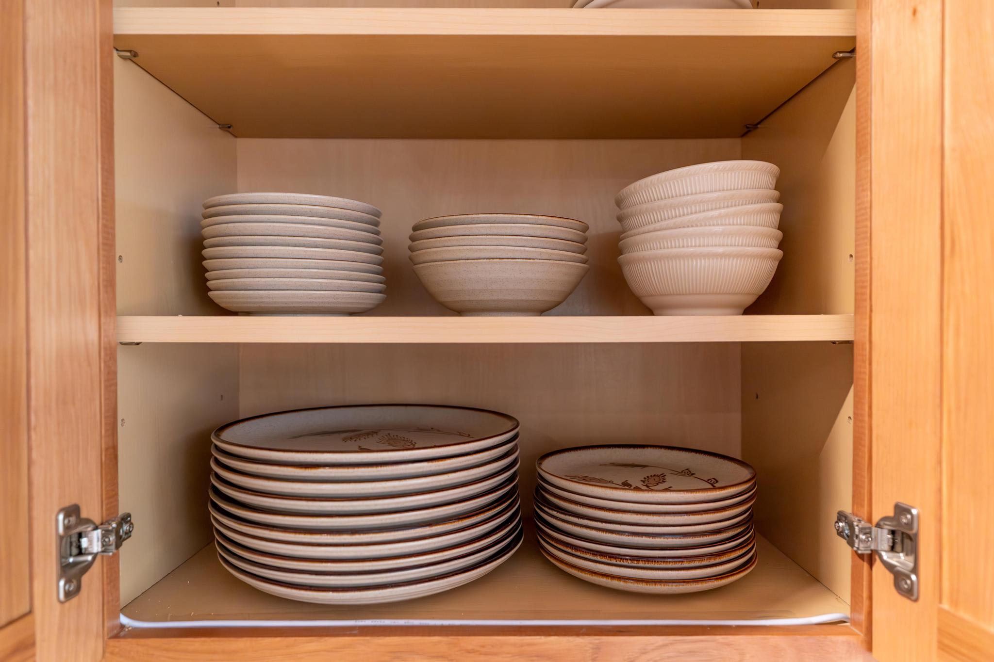 Neatly arranged dishes in a kitchen cabinet at a Truckee vacation rental.