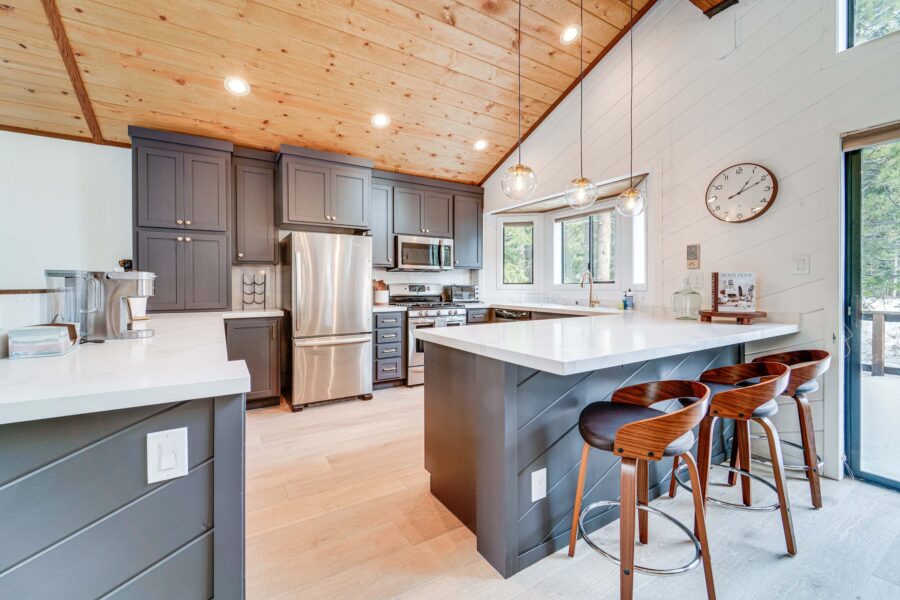 Modern kitchen in a Truckee vacation rental with dark cabinets, stainless appliances, and bar seating.