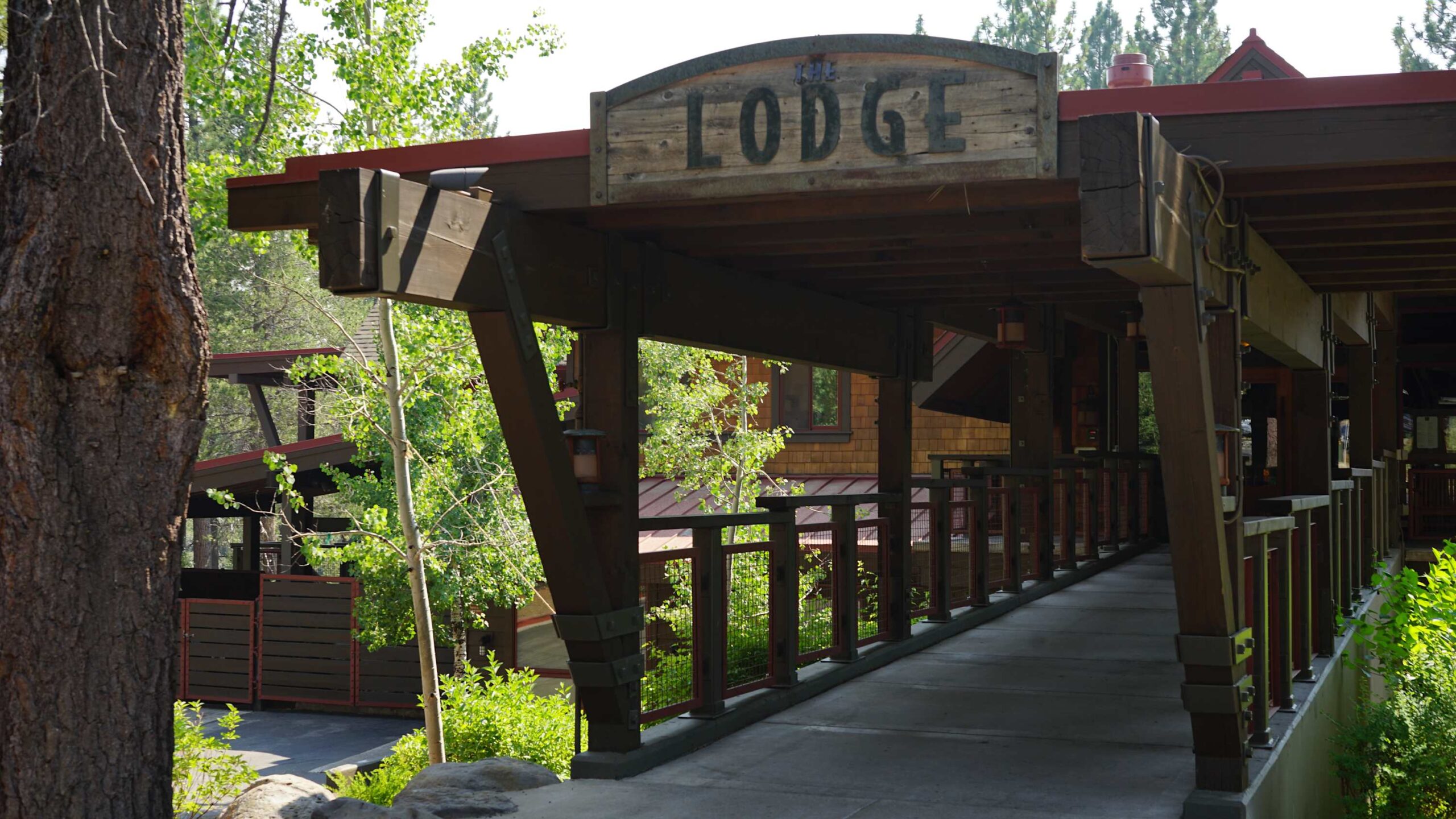 Rustic lodge entrance in Truckee, surrounded by greenery; perfect for a tranquil vacation rental escape.