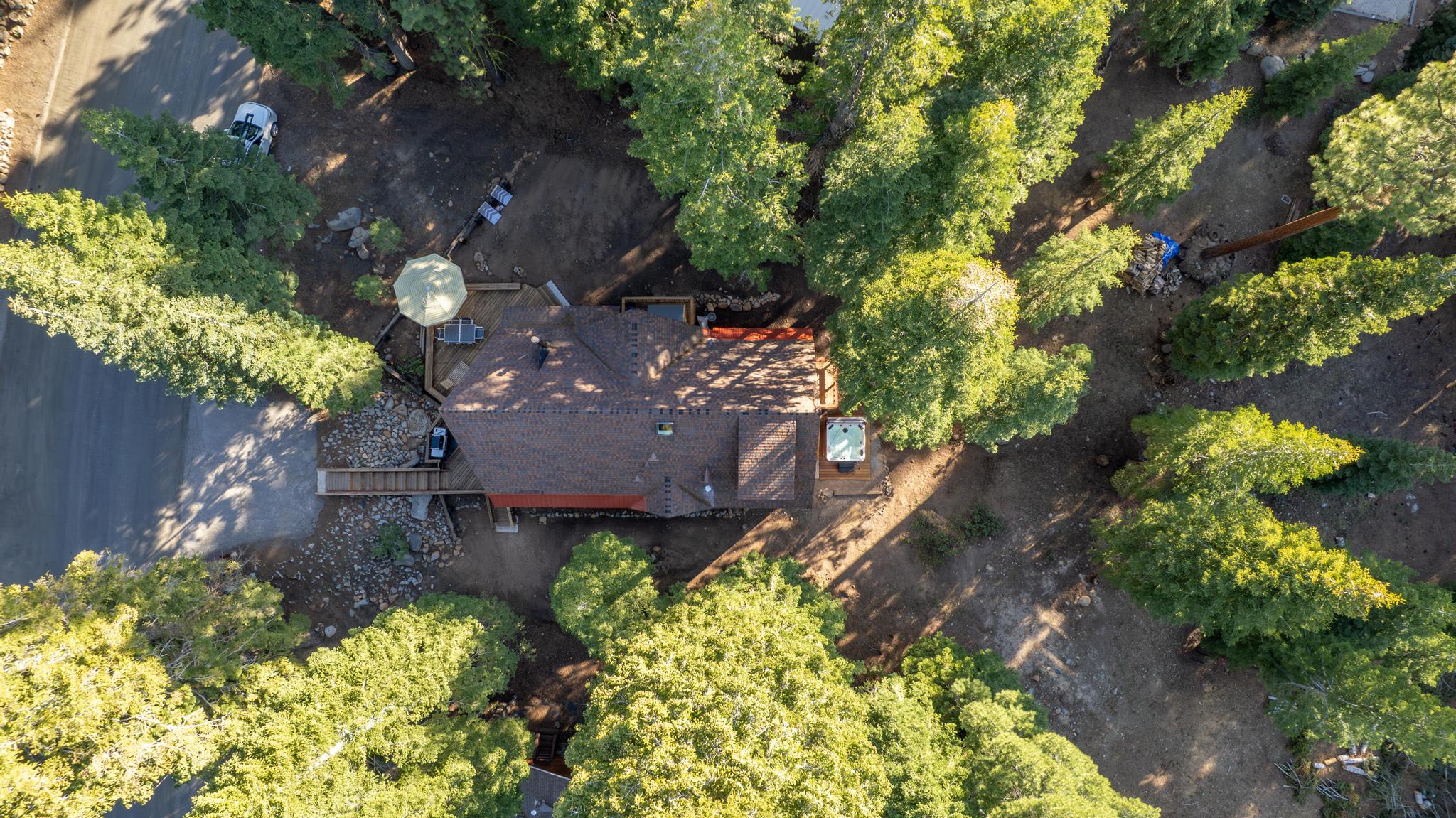 Aerial view of a vacation rental cabin surrounded by trees in Tahoe Vista.