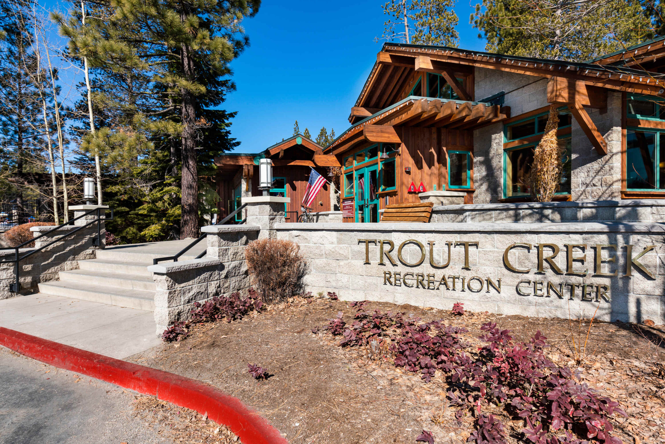 Trout Creek Recreation Center in Truckee, ideal for a vacation rental, surrounded by trees and stone architecture.