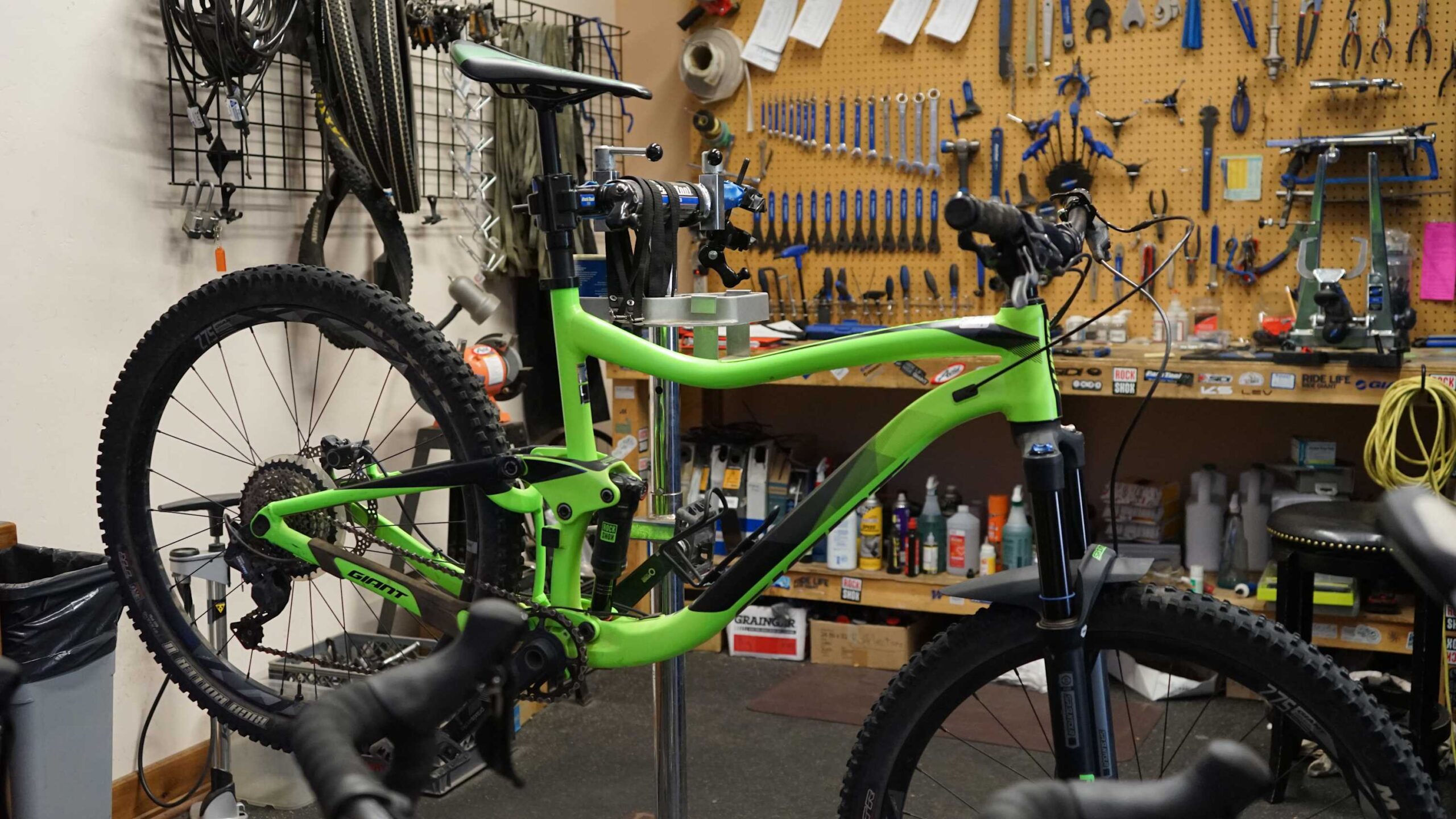 Mountain bike in a Truckee vacation rental workshop, surrounded by tools on a pegboard wall.