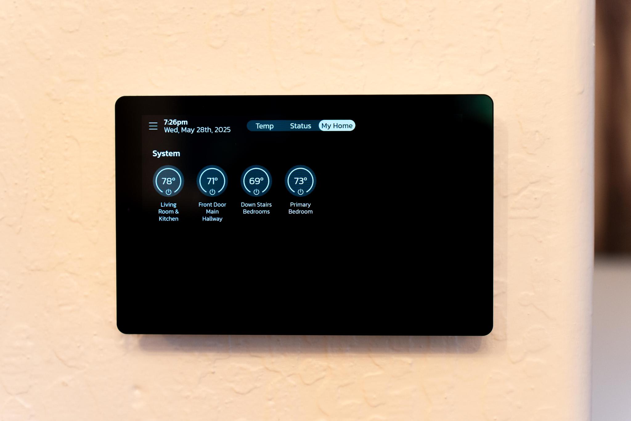 Smart thermostat screen in a Truckee vacation rental, displaying temperatures for different rooms.
