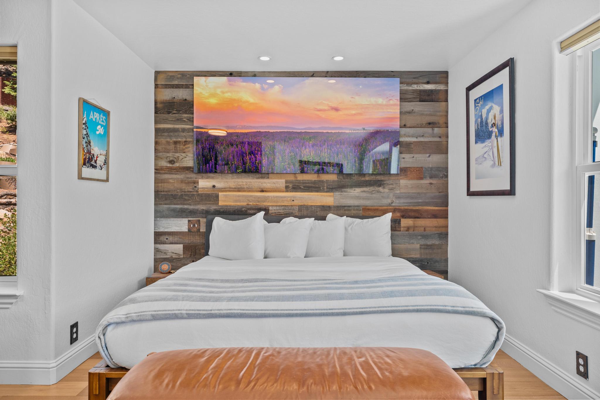 Cozy bedroom in a Truckee vacation rental with rustic wood accents and colorful wall art above the bed.