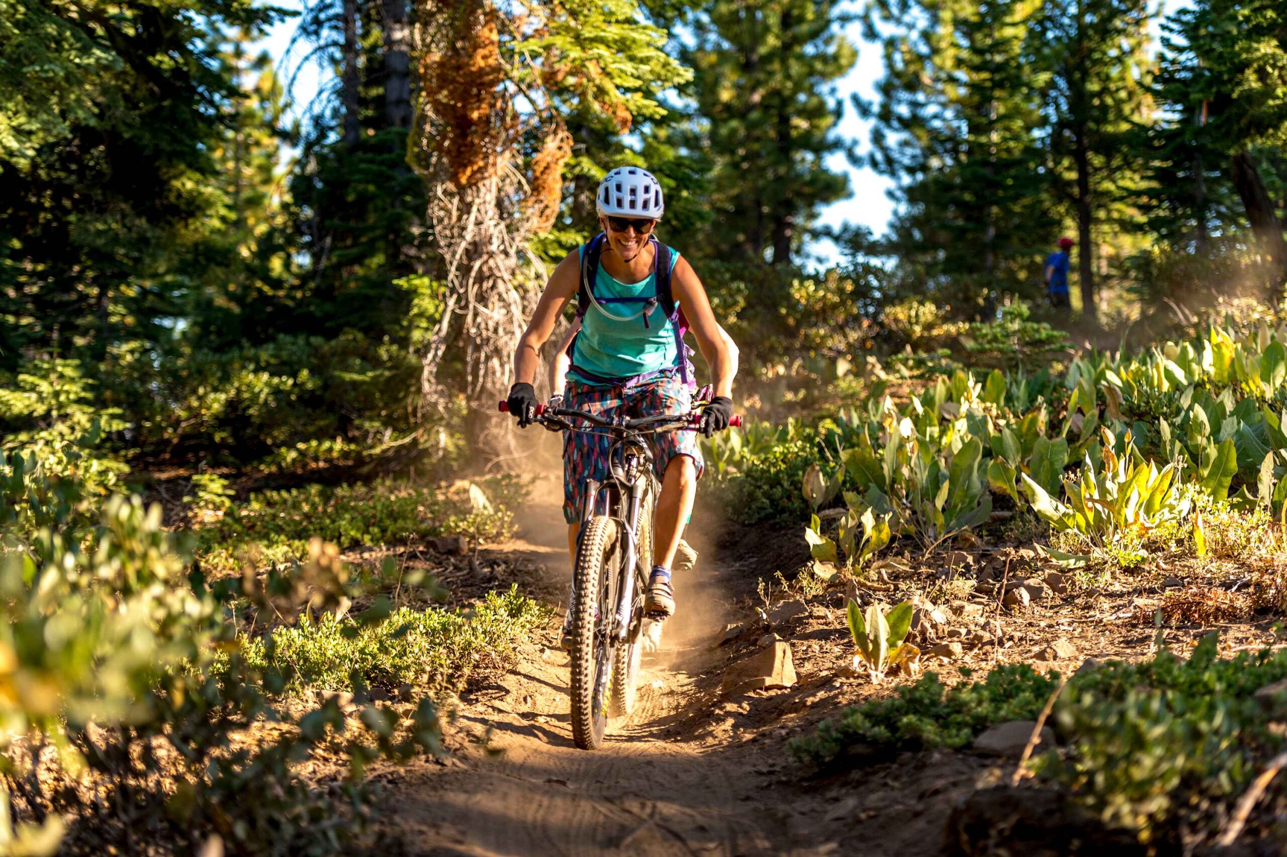 Cyclist rides through a forest trail in Truckee, ideal for adventure seekers looking for a vacation rental nearby.