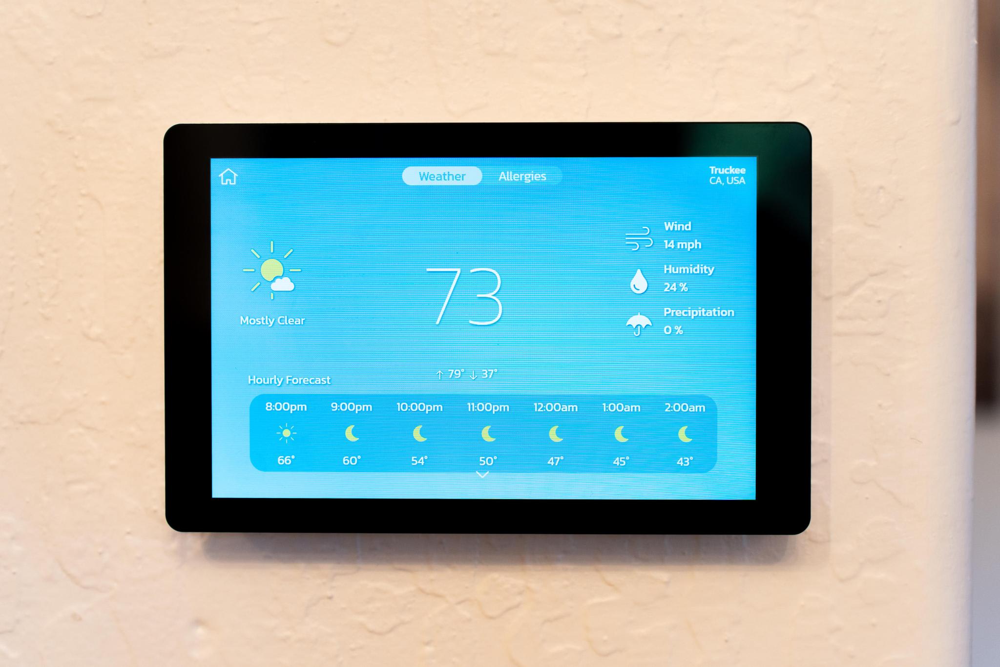 Smart thermostat displaying weather forecast in a Truckee vacation rental, showing 73°F and mostly clear skies.