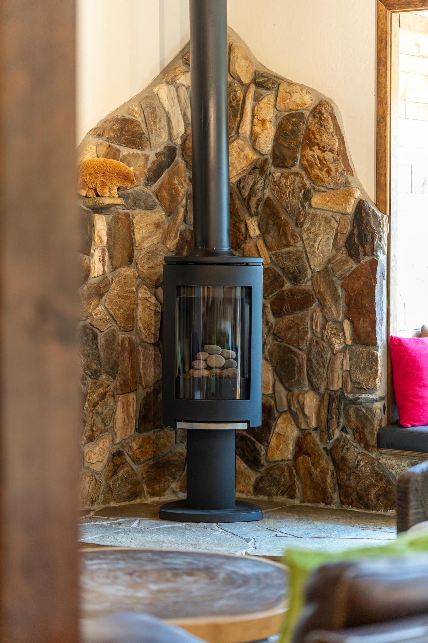 Cozy stone fireplace in a Tahoe Vista vacation rental, with a warm ambiance and rustic decor.