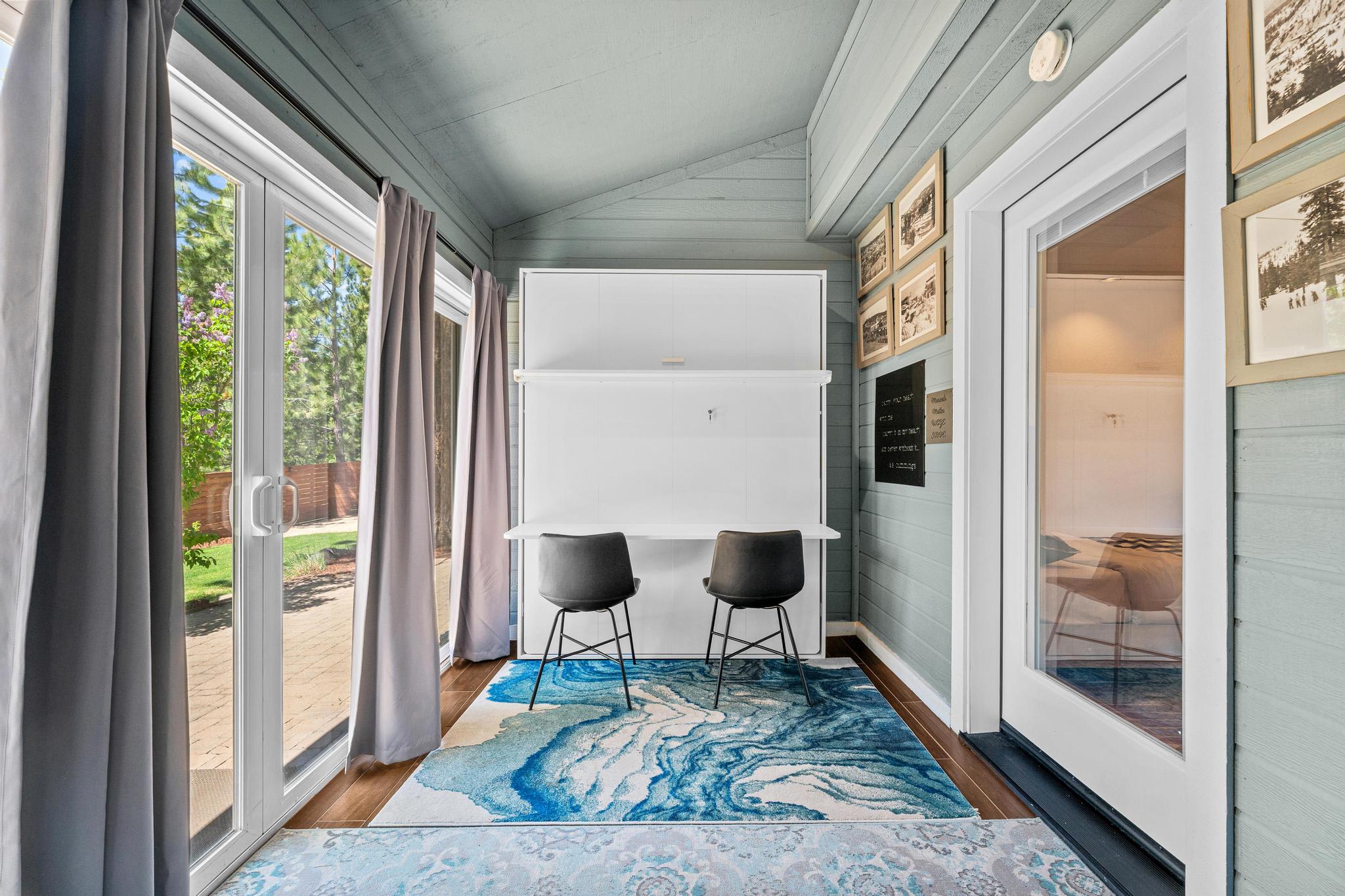 Cozy Truckee vacation rental with modern interior, sliding glass doors, outdoor view, and stylish blue and white decor.