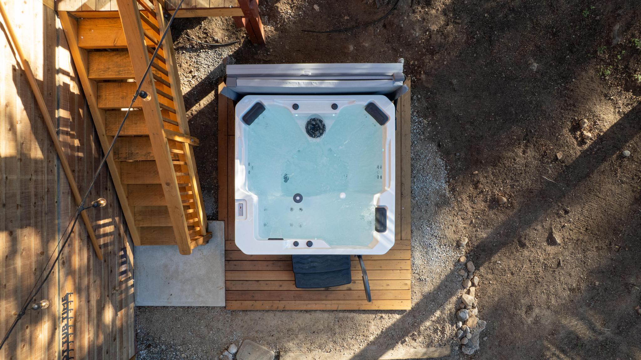 Overhead view of a hot tub next to wooden stairs in a Tahoe Vista vacation rental.