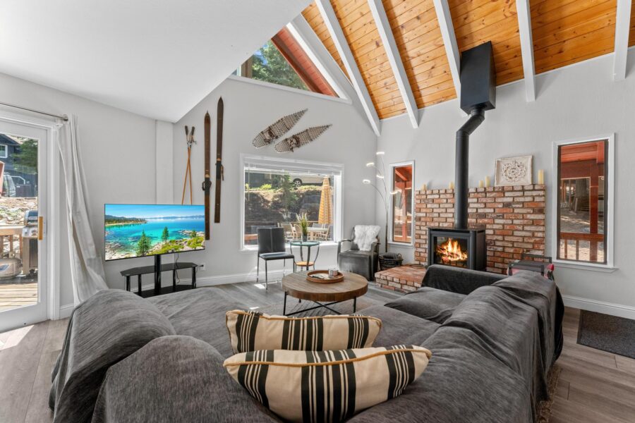 Cozy Tahoe Vista vacation rental with vaulted wood ceiling, a fireplace, modern TV, and stylish decor.