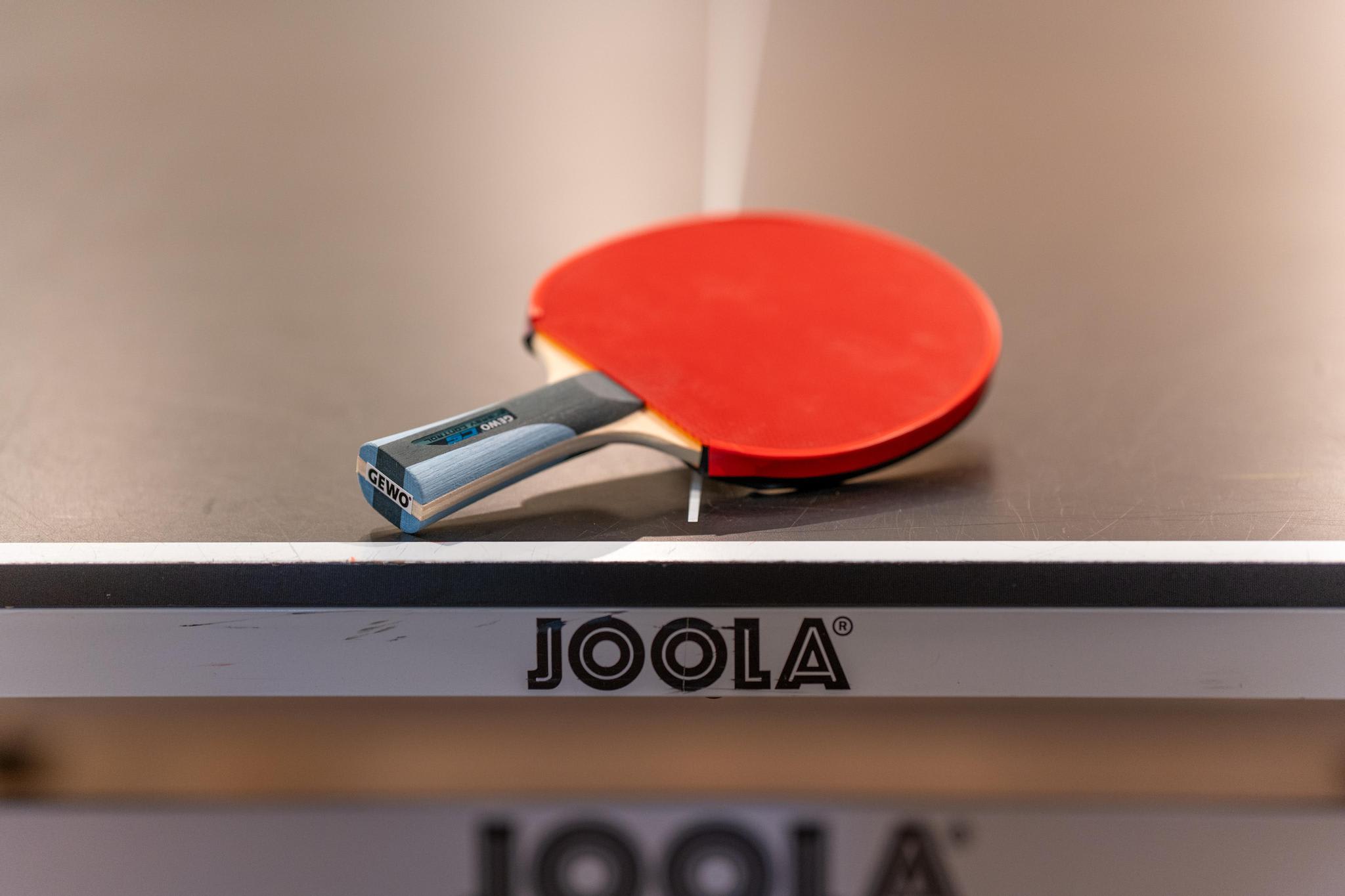 Table tennis paddle on Joola table in a Tahoe Vista vacation rental, ready for play.