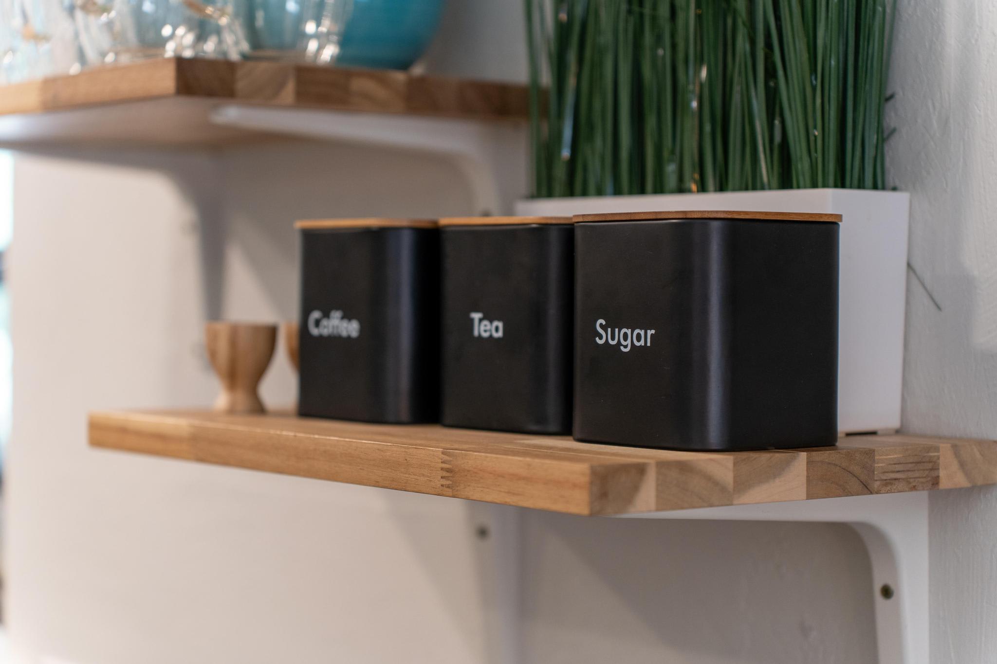 Kitchen shelf with coffee, tea, and sugar canisters in a Tahoe Vista vacation rental.