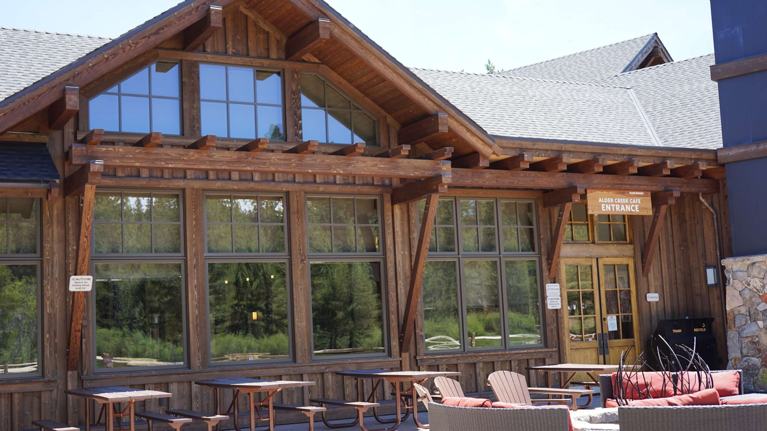 Rustic wooden vacation rental in Truckee with large windows, cozy seating, and forest views.