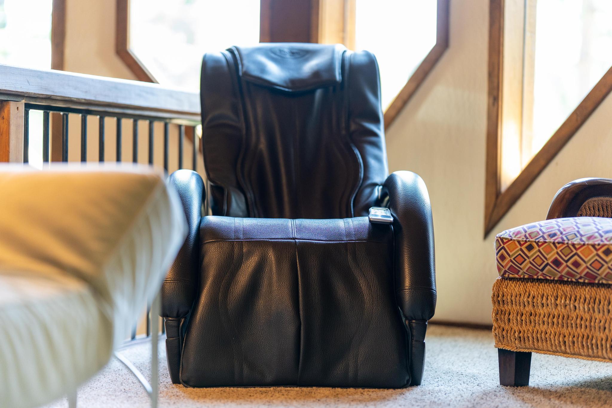 Leather massage chair in a Tahoe Vista vacation rental, surrounded by cozy seating and warm natural light.