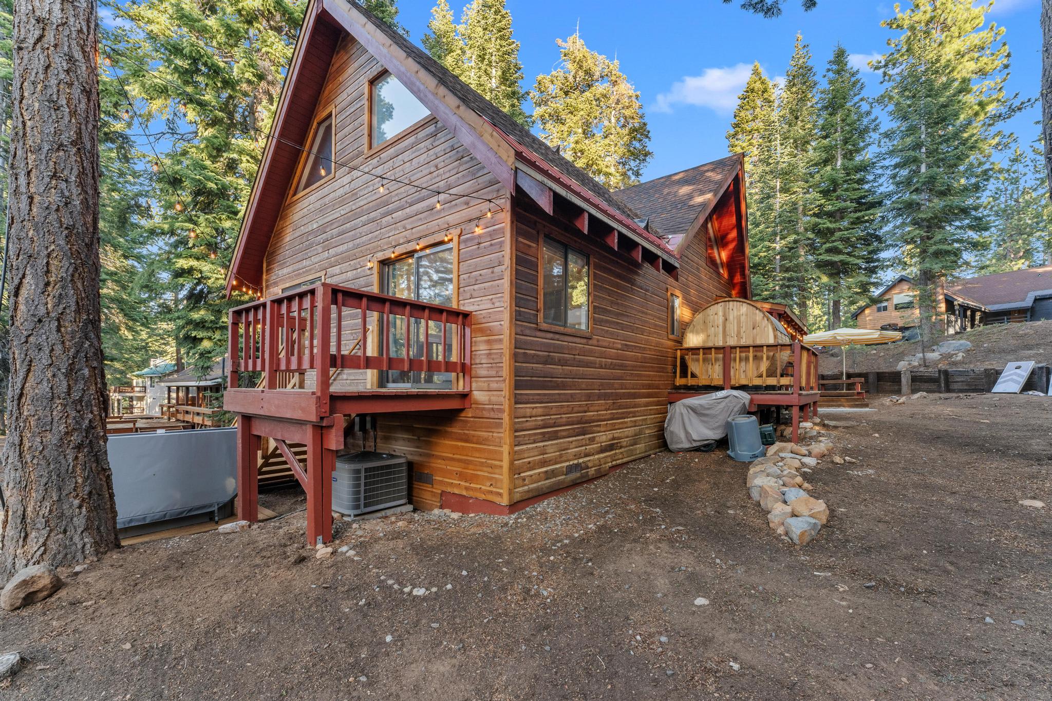 Cozy wooden cabin vacation rental in Tahoe Vista, surrounded by tall trees and set in a serene, natural setting.
