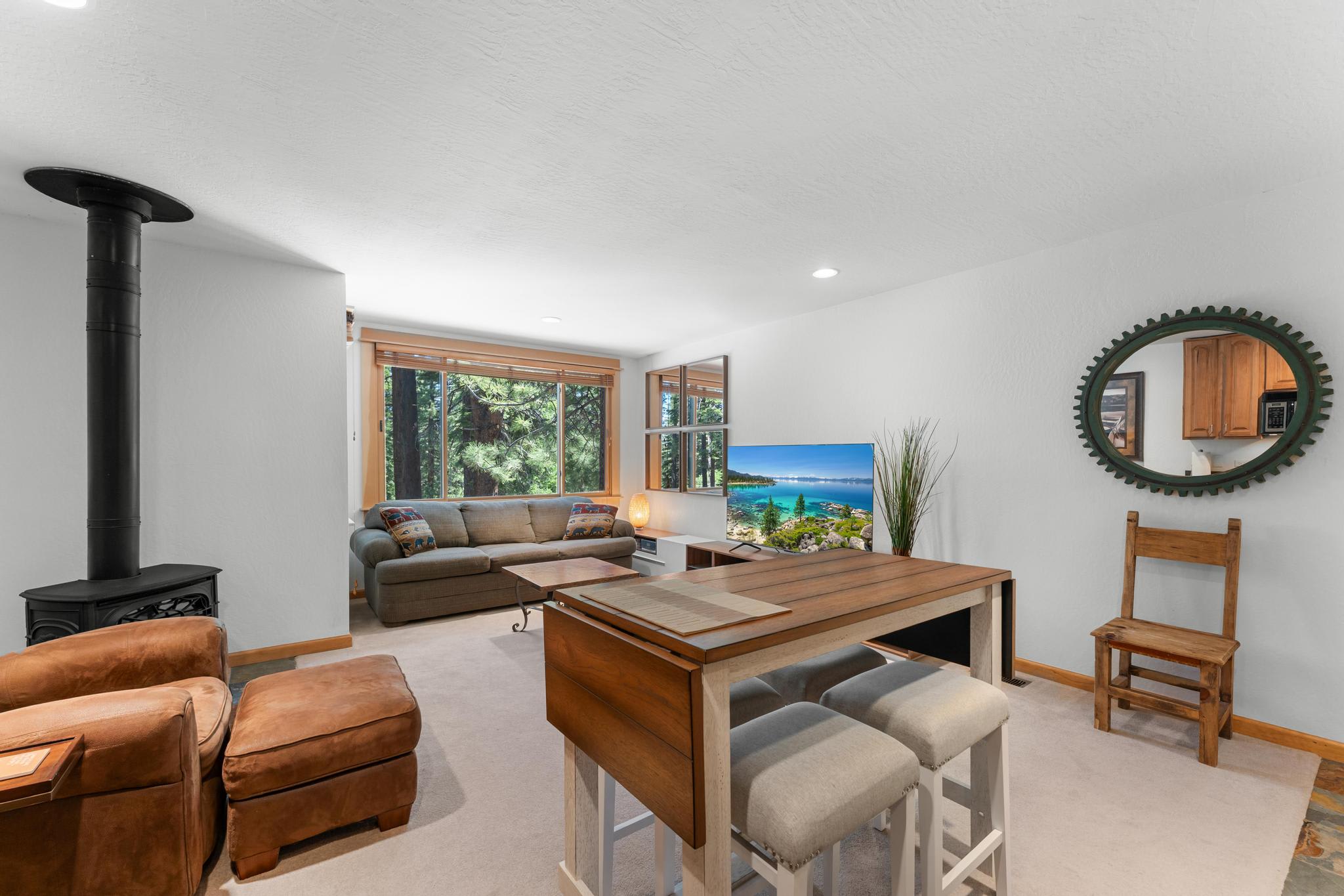 Cozy living area in Truckee vacation rental with forest views, modern decor, and plush seating.