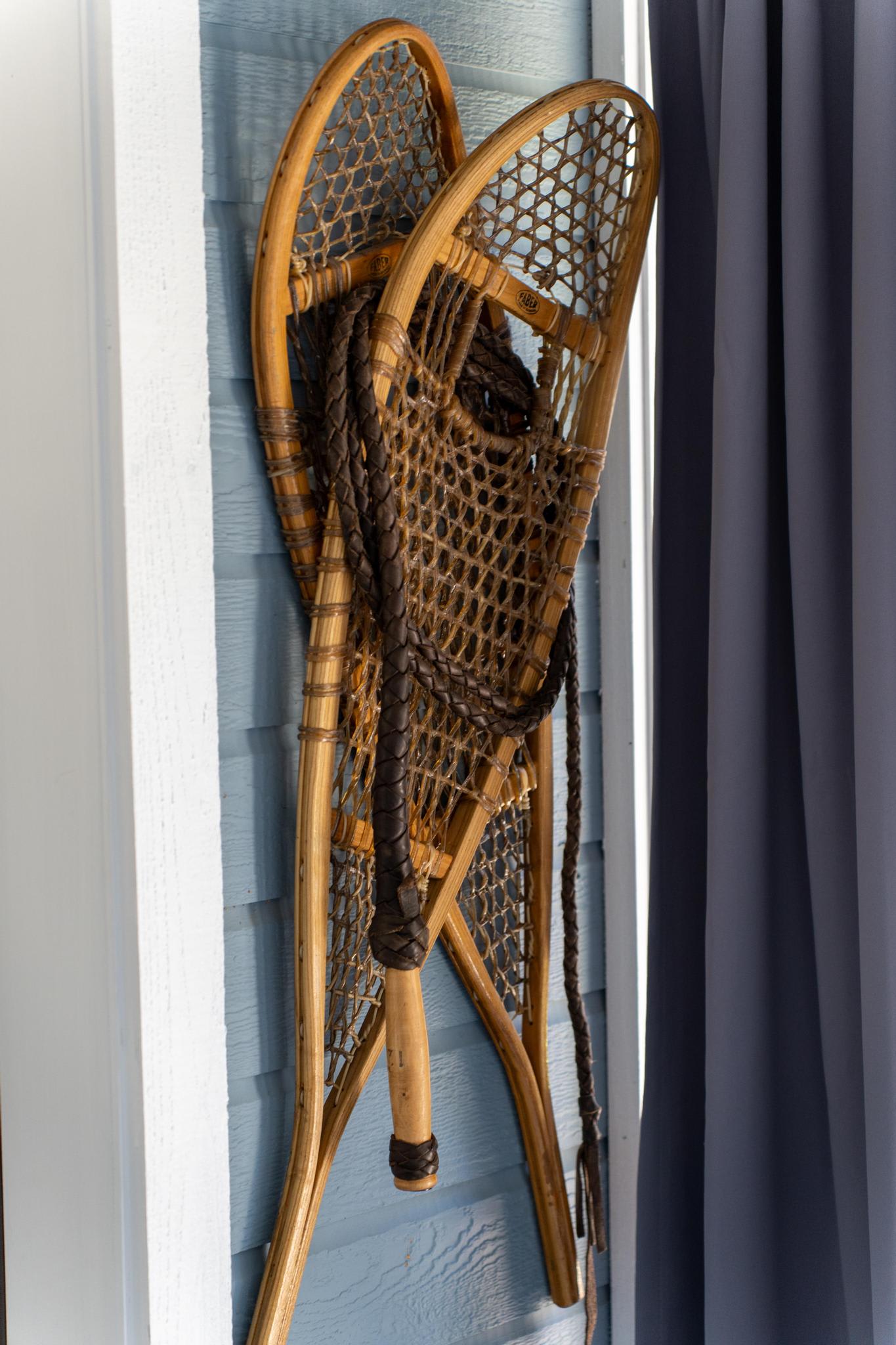 Vintage wooden snowshoes on a blue wall in a Truckee vacation rental, adding rustic charm to the decor.