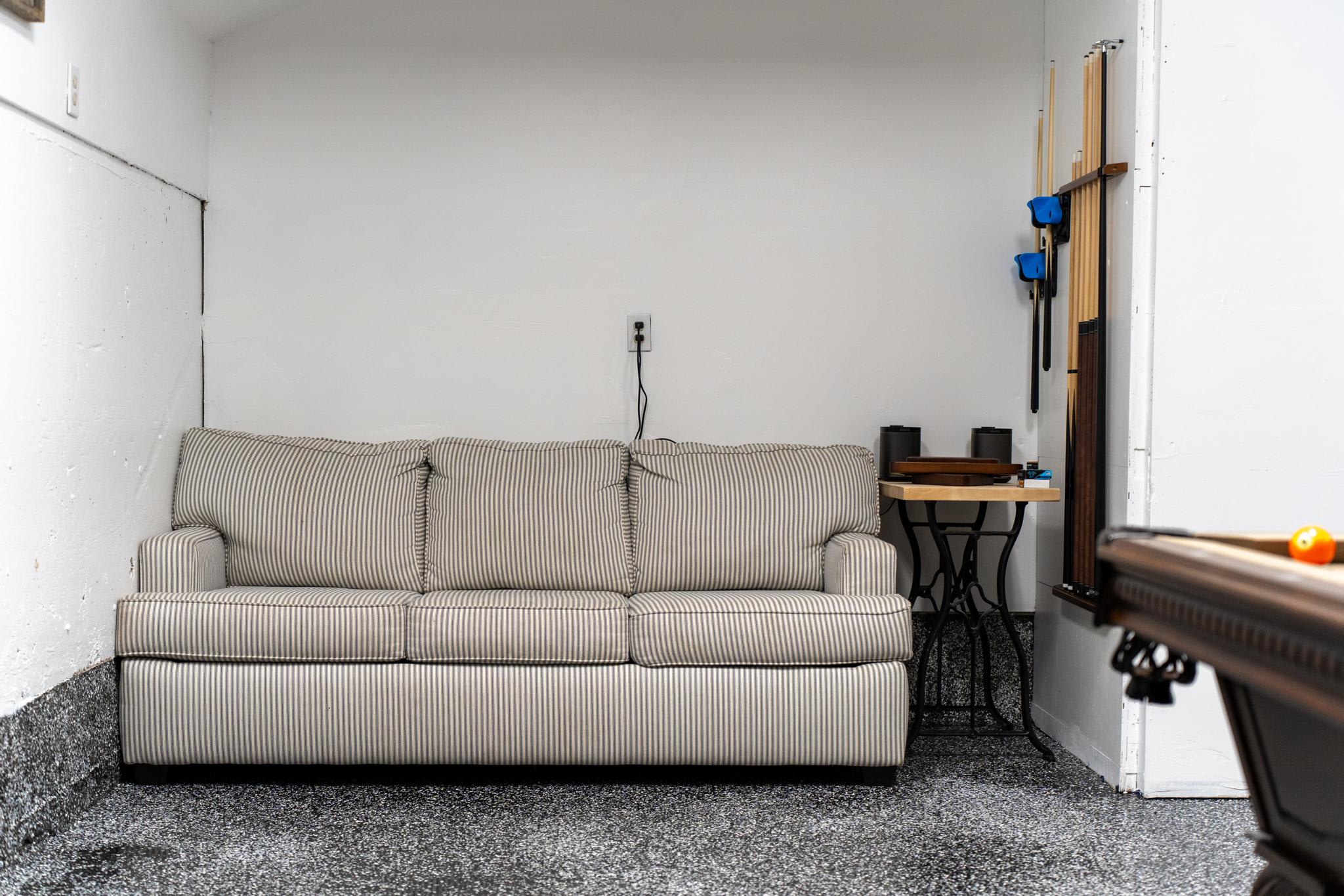 Sofa and pool table in a Truckee vacation rental with a cozy game room setup.