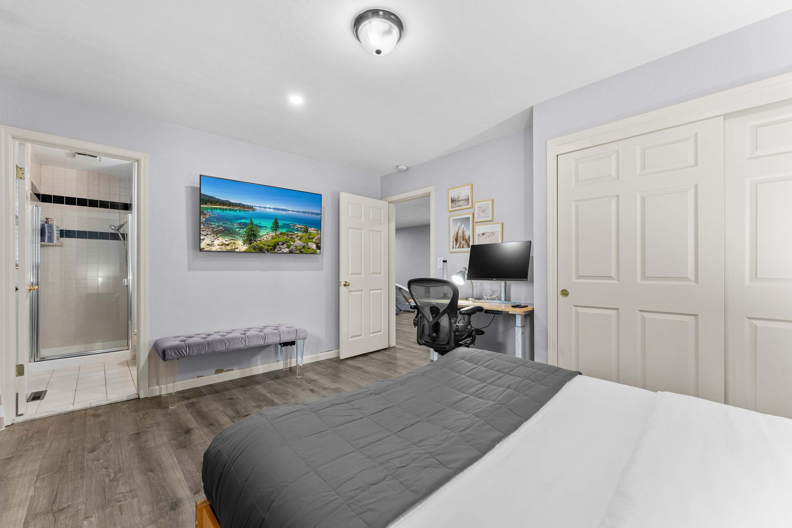 Modern bedroom in Truckee vacation rental with desk, computer, and ensuite bathroom.