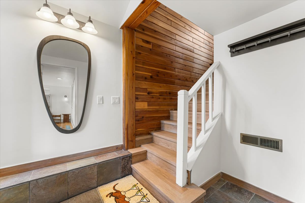 Staircase with wooden paneling and modern decor in a Kings Beach vacation rental.