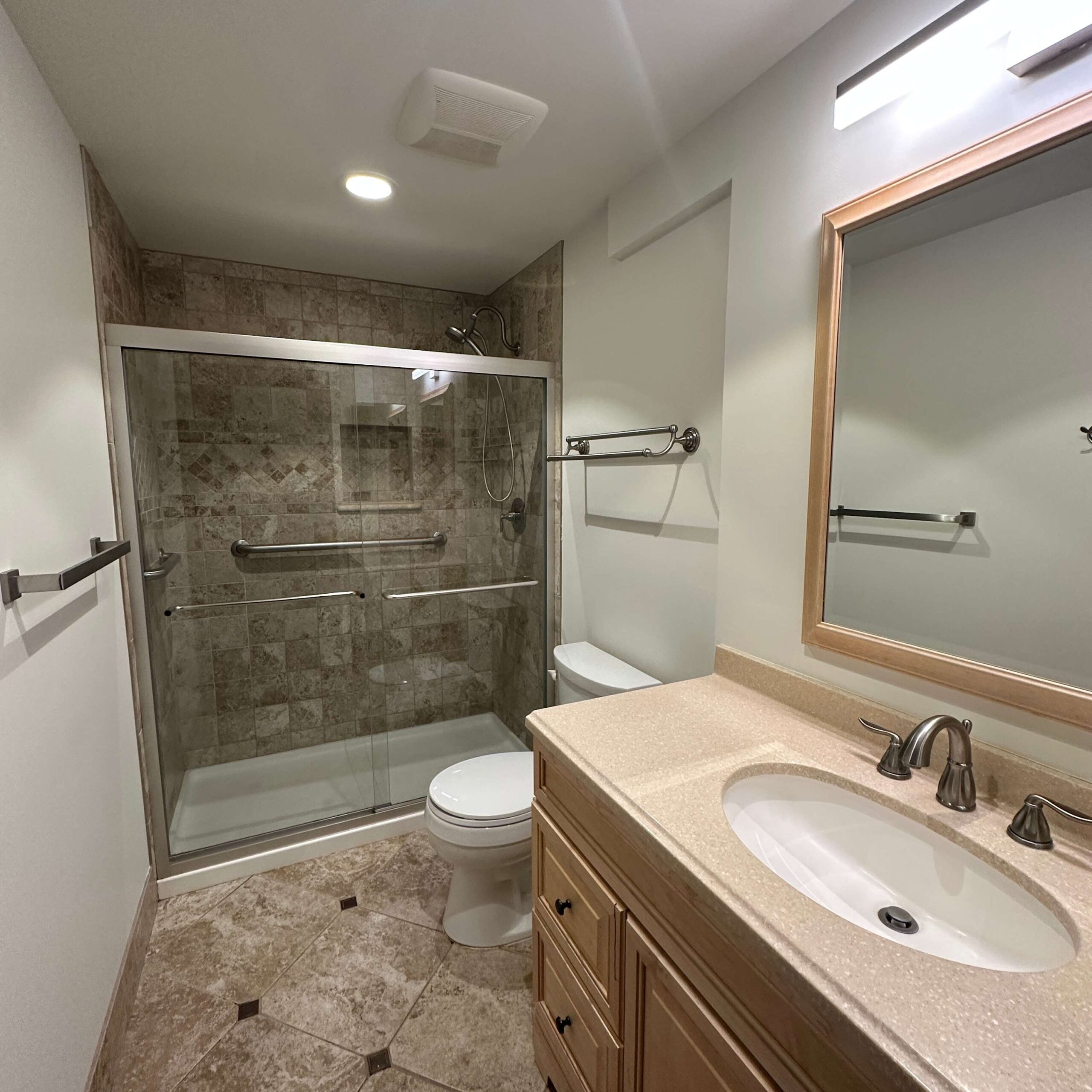 Bathroom in a Kings Beach vacation rental featuring a glass-enclosed shower, vanity, and neutral decor.