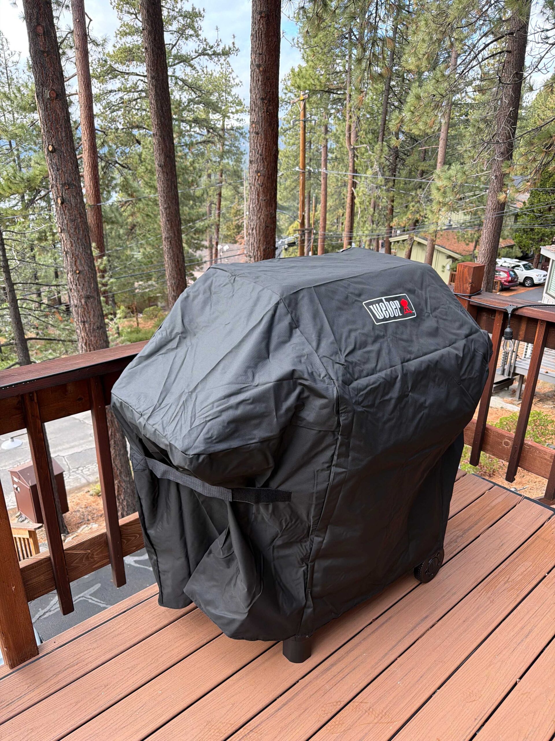 Covered grill on a wooden deck overlooking trees at a Kings Beach vacation rental.