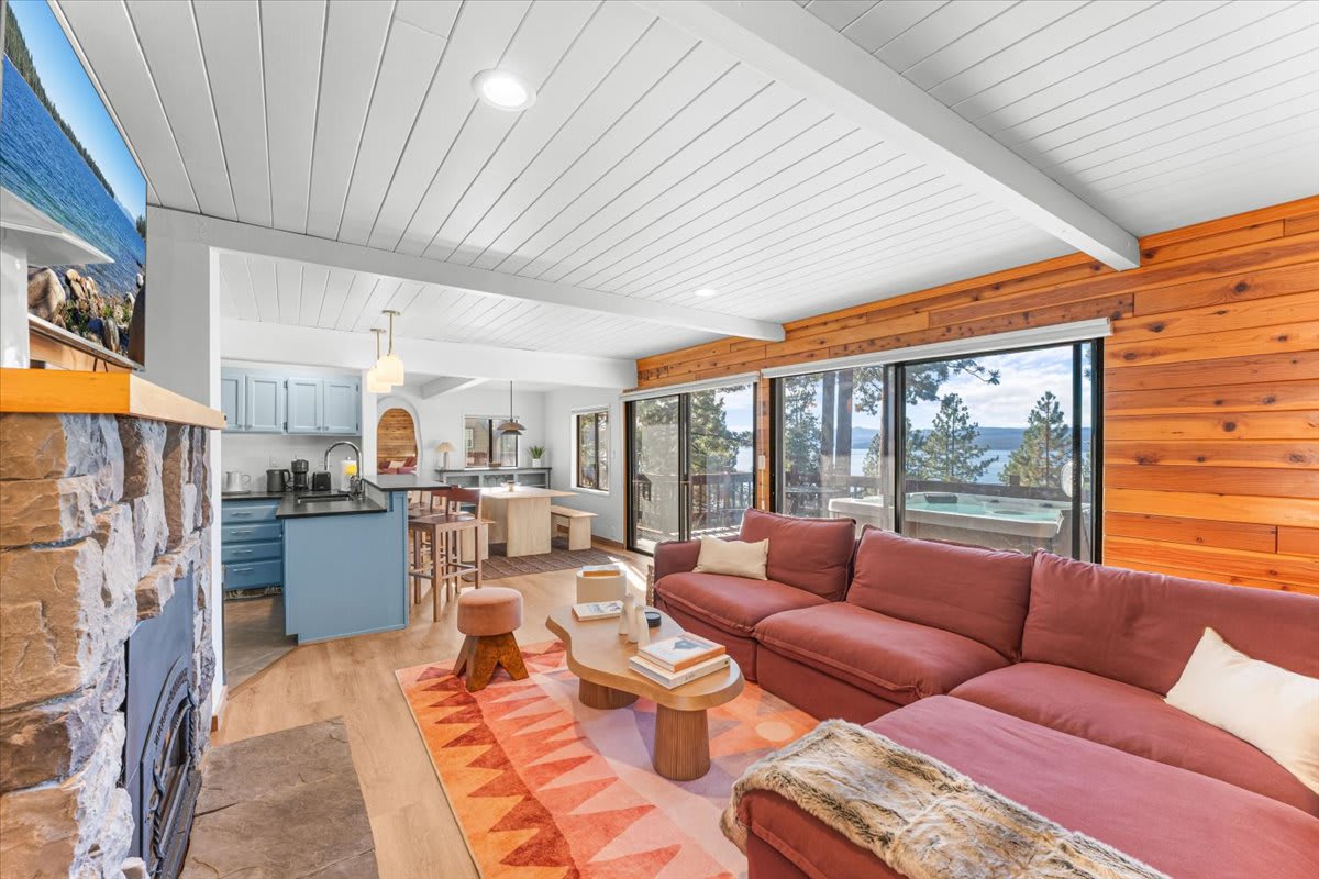 Stylish vacation rental in Kings Beach with lake views, modern kitchen, and cozy living area featuring a red sofa.