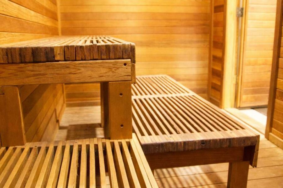 Cozy wooden sauna interior at a Truckee vacation rental, featuring slatted benches and warm lighting.