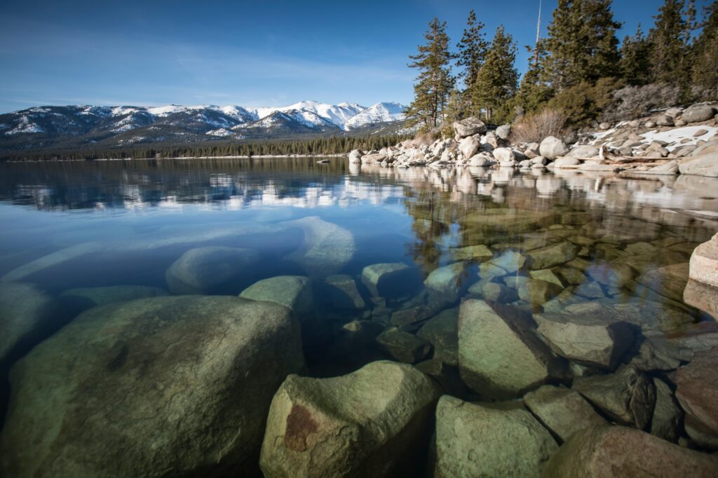 clear waters lake tahoe snow on mountains