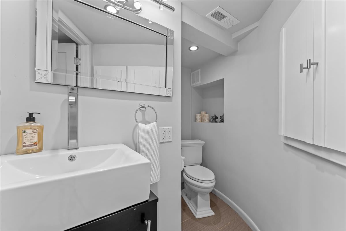Modern bathroom in a Kings Beach vacation rental, featuring a white sink and toilet with stylish decor.