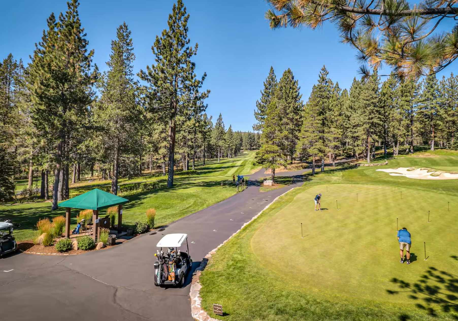 Golf course view in Truckee with a putting green and golf carts, ideal for vacation rental stays.