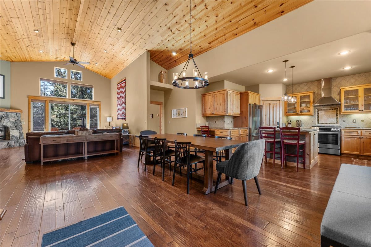 Spacious Truckee vacation rental with wooden interiors, large windows, and an open kitchen and dining area.