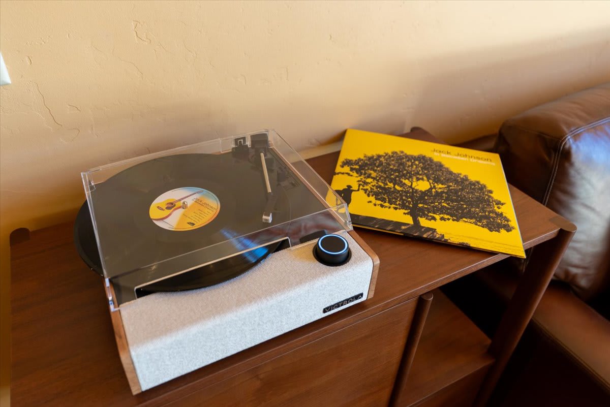 Record player and album on a wooden table in a Truckee vacation rental living room.