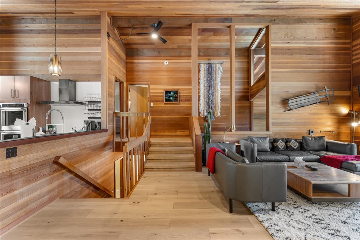 Modern, wood-accented vacation rental in Carnelian Bay with cozy seating, open kitchen, and rustic decor.