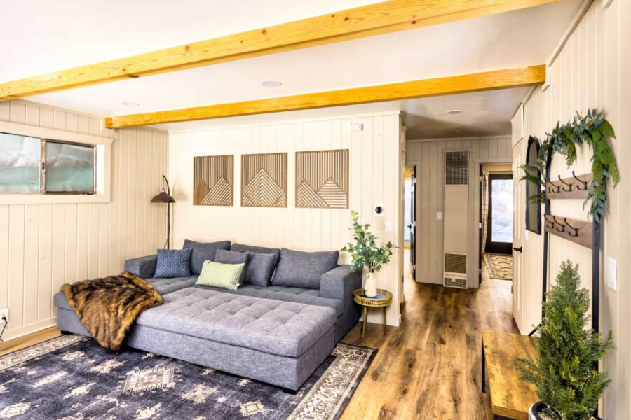 Modern living room in a Kings Beach vacation rental, featuring a comfy gray sofa, wood accents, and stylish decor.